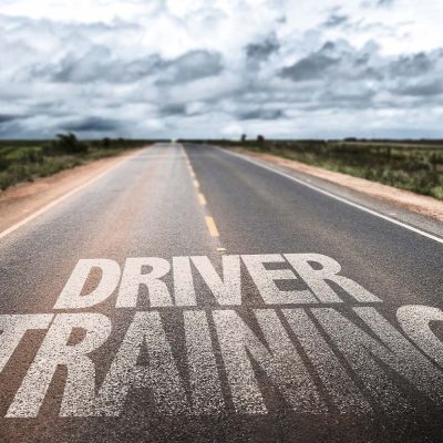Driver training written on a road
