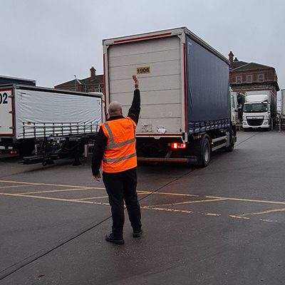 Banksman signalling a reversing lorry